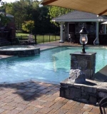 A – Poolside patio overlooks vanishing edge overflow wall.