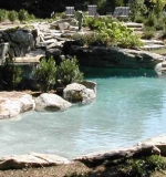 Beach entry pool with sunken boulders, hidden lagoon and waterfall.