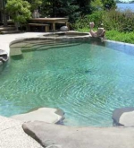 A – Freeform pool with vanishing edge overlooking the bay. Attached spa, custom walk-in stairs and sun shelf area.