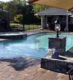 A – Poolside patio overlooks vanishing edge overflow wall.