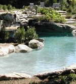 Beach entry pool with sunken boulders, hidden lagoon and waterfall.