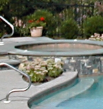 Detail of fully integrated spa with overflow into freeform pool.