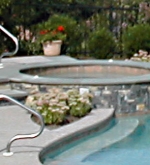 Detail of fully integrated spa with overflow into freeform pool.