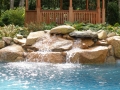 Small waterfall turns this freeform pool into a stunning focalpoint for the yard.
